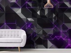 a white couch sitting in front of a black wall with purple geometric designs on it