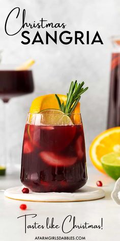 a christmas sangria with orange slices and rosemary garnish