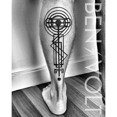 a man's leg with an abstract tattoo on it