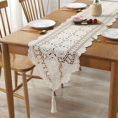 an image of a table setting with place settings and lace doily on the table