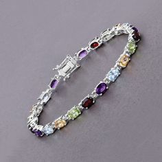 "Multi Stone Bracelet, Natural Multi Stone Oval Tennis Bracelet in .925 Sterling Silver, Gifts for Her, Multi Color Gemstone Flaunt yourself with this multi-stone tennis bracelet. The natural gemstones have a combined weight of 10.13 carats and are set in .925 sterling silver with rhodium plating. The multi-color hue of this bracelet adds a pop of color to any look! The understated design and vibrant stones make this bracelet perfect for every occasion. .925 Sterling Silver Item Type: Bracelet G Silver Oval Bracelets With Gemstone Accents, Sterling Silver Multi-stone Bracelet, Silver Multi-stone Tennis Bracelet, Oval Sterling Silver Bracelets With Multi-stone, Elegant Sterling Silver Multi-stone Bracelet, Luxury Multi-stone Sterling Silver Bracelet, Elegant Multicolor Multi-stone Sterling Silver Bracelet, Multicolor Cubic Zirconia Multi-stone Bracelets, Colored Stones