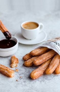 some churros are next to a cup of coffee