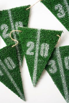 green grass pennants with white numbers on them