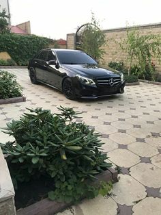 a black car is parked in the driveway