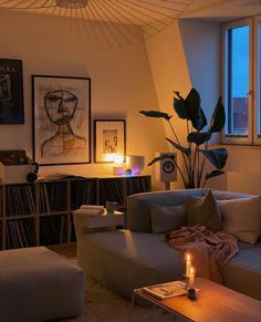 a living room filled with furniture and a lit candle in the middle of the room