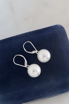 "Vintage Sterling Silver Faux Pearl Dangle Earrings. Length: 1 1/4\" Weight: 5.5 grams  Marked: 925 Vintage condition! For more earrings: https://www.etsy.com/shop/SusVintage?ref=hdr_shop_menu§ion_id=14261313 Back to the shop: https://www.etsy.com/shop/SusVintage?ref=hdr_shop_menu Don't hesitate to contact me if you have any further questions. Thank you for looking!!" Classic Sterling Silver Drop Clip-on Earrings, Sterling Silver Drop Pearl Earrings With Lever Back, Silver Round Pearl Earrings With Lever Back, Silver Pearl Earrings With Lever Back, Silver Pearl Earrings With Lever Back For Formal Events, Silver Pearl Earrings With Lever Back For Formal Occasions, Classic Nickel Free Drop Earrings, Nickel-free Classic Drop Earrings, Classic Formal Nickel-free Earrings