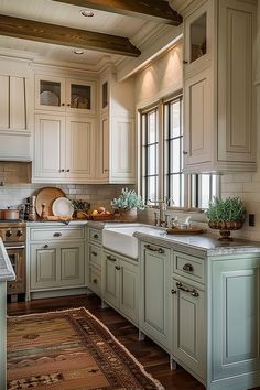 a kitchen filled with lots of white cabinets and counter top space next to a window