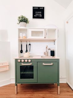 a green stove top oven sitting inside of a kitchen