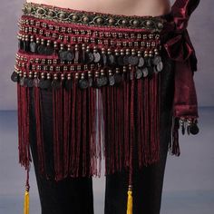 a woman's belly is adorned with beads and tassels on her waist