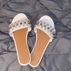 White Bedazzled/Rhinestone Slide On Sandals. Never Worn.. Purchased From Macy’s Last Year White Synthetic Sandals With Rhinestones, White Open Toe Sandals With Rhinestones, White Rhinestone Open Toe Sandals, White Rhinestones Open Toe Sandals, Embellished White Synthetic Sandals, Spring Bedazzled Flat Sandals, White Embellished Open Toe Sandals, Flat Synthetic Sandals With Bling, White Embellished Flat Heel Sandals