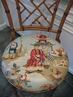 a wooden chair with a colorfully decorated seat