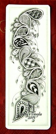 an ornate design on the back of a white card with red trimming and black border