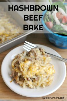 hashbrown beef bake on a white plate with a fork and salad in the background