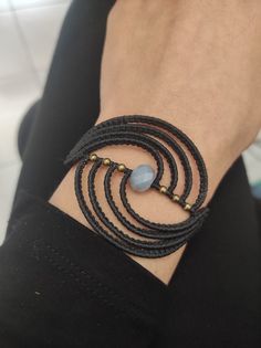 a close up of a person's wrist wearing a bracelet with beads on it