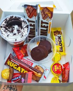 a box filled with assorted chocolates and candy bar items, including an ice cream sundae