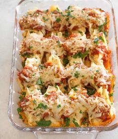 lasagna casserole with meat and cheese in a glass dish on a table