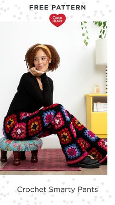 a woman sitting on top of a stool with her legs crossed and wearing crochet pants