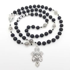 Solid and masculine  personalised Rosary beads made with black lava beads with indents and a rough texture and complimented by silver toned tibetan beadspearls for Our Father. The crucifix is a 3-Way Pardon Indulgence crucifix which includes the Miraculous Medal and St. Benedict Medal. St. Pope Pius X approved the granting of indulgences for those who use a Pardon crucifix on 1st June 1905.  Great gift for a male and for many occasions such as a confirmation, first holy communion and much more! Spiritual Black Beads With Silver Accents, Adjustable Black Rosary With 8mm Beads, Black Lava Stone Jewelry With Black Beads, Rosary For Men, Personalized Rosary, 1st June, Benedict Medal, Praying The Rosary, Holy Rosary