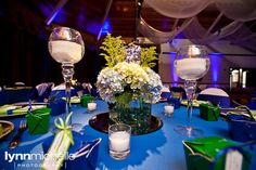 the centerpieces are decorated with flowers, candles and napkins for an elegant wedding reception