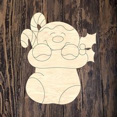 a wooden cutout of a koala bear on a wood background with text that reads,