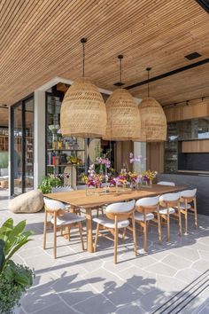 an image of a table and chairs in the middle of a room with wooden ceilinging