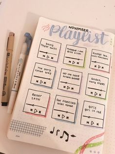 a notebook with some writing on it next to a pen and marker, which says november playlist