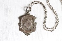 "This striking necklace is In great solid vintage condition, beautifully and naturally aged, all darkened and oxidised by time with original patina. The pendant is an original antique watch fob, roughly 1.25\" tall, bearing full British hallmarks for Birmingham sterling silver, dated 1953-1954,  Dangles from a silver rolo chain 16\" long that fastens with a classic round spring clasp, also stamped 925 for sterling silver. Perfect to wear on it's own, or to layer with other necklaces. For more vi Antique Silver Stamped Necklaces, Antique Silver Stamped Necklace, Vintage Oxidized Medallion Jewelry, Vintage Medallion Jewelry With Oxidized Finish, Vintage Stamped Pendant Necklace, Vintage Stamped Necklaces, Vintage Medallion Necklace With Oxidized Finish, Vintage Jewelry With Oxidized Finish, Antique Watch