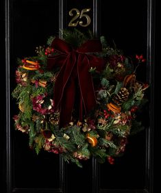 a christmas wreath hanging on the front door