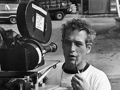 black and white photograph of a man with headphones in front of a movie projector