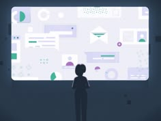 a person standing in front of a large screen with various icons on it and the man is looking at it