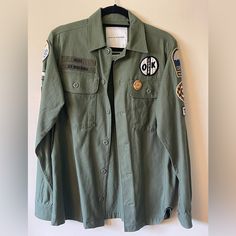 Army Green, Never Worn But No Longer Has Tags. Rare- I Cannot Find One Online With Any Of The Same Patches. Long Sleeve Tops With Patch Pockets For Streetwear, Cotton Long Sleeve Tops With Patches, Graphic Print Cotton Outerwear For Work, Casual Outerwear With Patches, Urban Fall Tops With Patch Pockets, Urban Tops With Patch Pockets For Fall, Military Style Button-up Tops For Streetwear, Military Style Tops With Patch Pockets For Fall, Urban Long Sleeve Workwear Tops