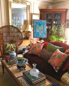 a living room filled with lots of furniture and pillows on top of a coffee table