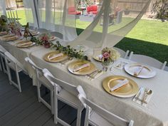 the table is set with gold plates and place settings