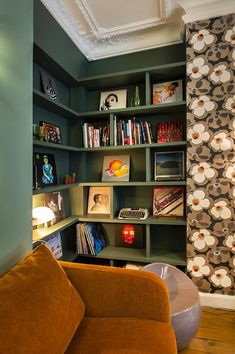 a living room filled with lots of bookshelves next to a wall mounted tv