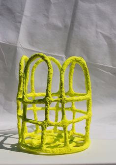 a yellow sculpture sitting on top of a white table