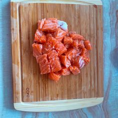 raw salmon on a cutting board ready to be cooked