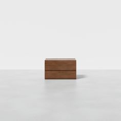 a wooden box sitting on top of a white floor