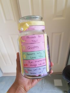 a person holding up a jar with notes in it and writing on the lid that says, phrases for you