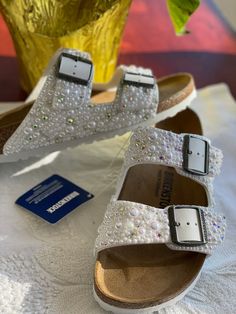 a pair of white sandals sitting on top of a table