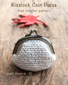 a crocheted coin purse sitting on top of a wooden table