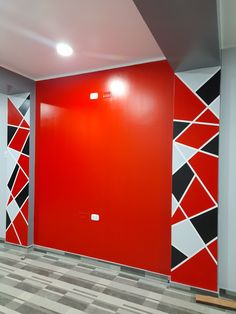 an empty room with red and black walls