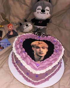 a heart shaped cake with an image of prince harry potter in the middle and other items around it