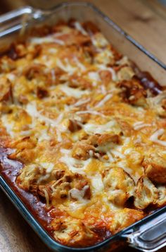 a casserole dish with meat and cheese in it on a wooden table top