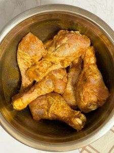 some chicken wings are in a metal bowl