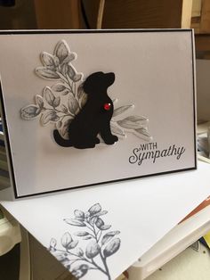 a close up of a greeting card with a dog and flowers on the front side