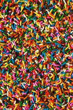 colorful sprinkles are scattered on top of each other