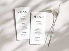 two menu cards sitting on top of each other