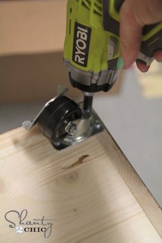 a person using a drill to cut wood