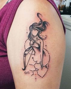 a woman's arm with a zodiac sign tattoo on the back of her shoulder