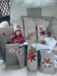 christmas presents wrapped in brown and white striped paper with red bows are stacked on top of each other